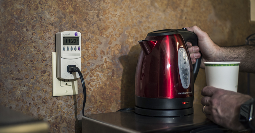 an electronic kettle plugged into a kill-a-watt monitor