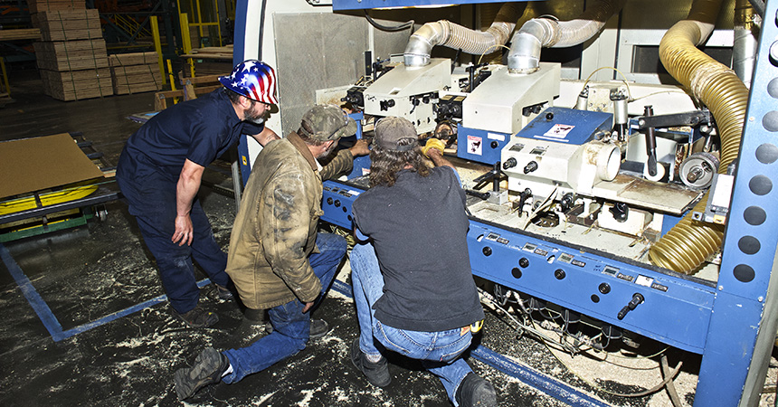 a group of three people examining equipment