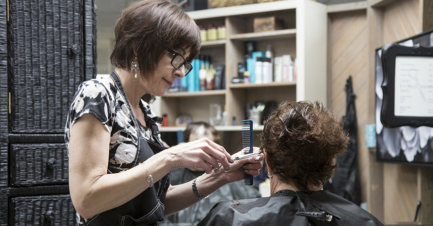 Beth Koblegarde cuts the hair of Carol Sutton at Shears Ahead salon, Tigard, Oregon, April 15, 2019.