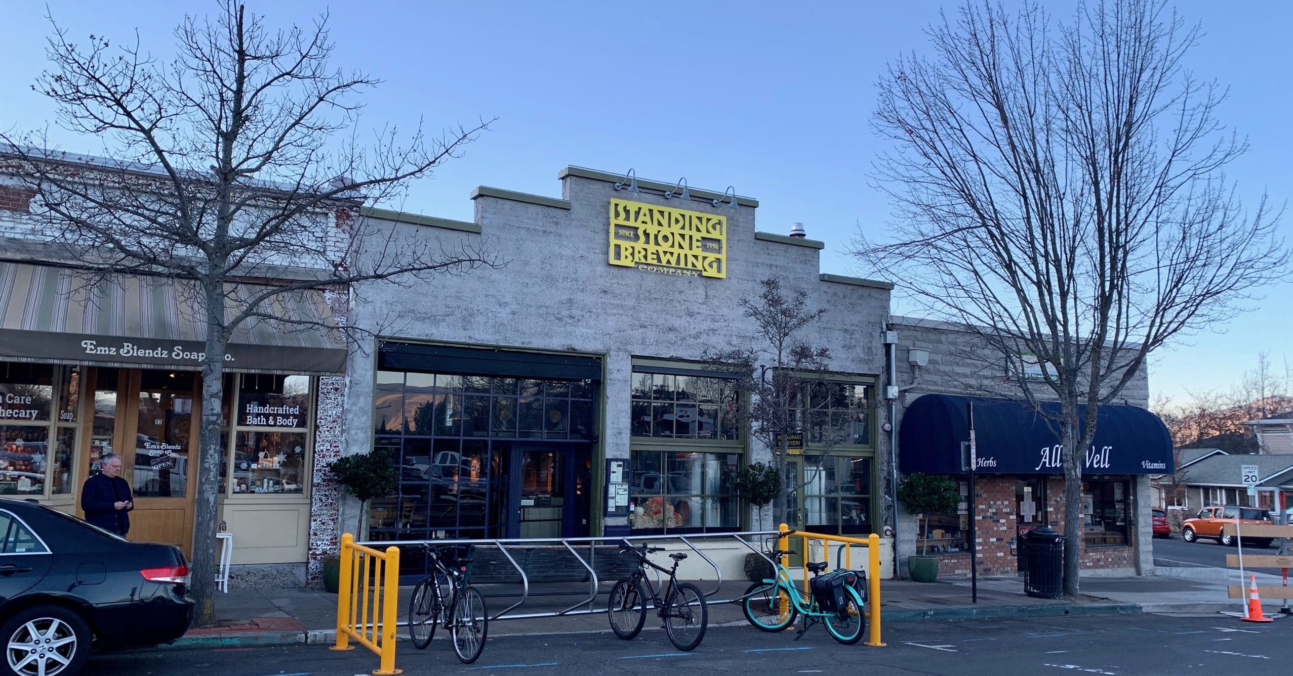 A brewery storefront with bike parking