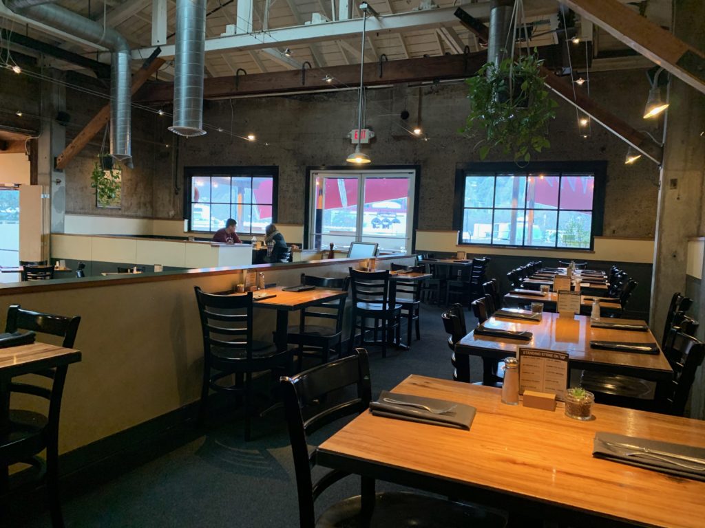 a brewery restaurant with tables and tvs