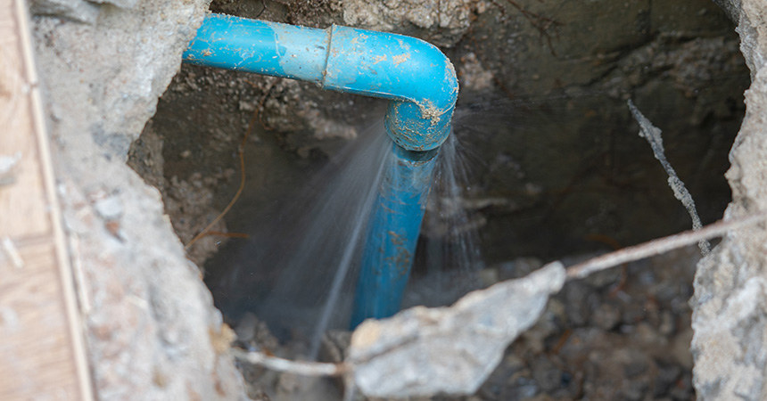 leaking water from blue pipe from underground