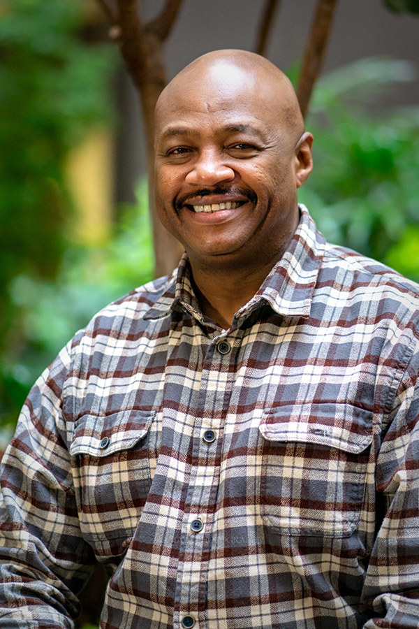 tyrone henry smiling in front of greenery