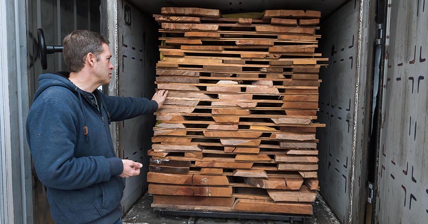 a man loading lumber into a truck