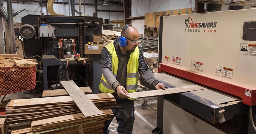 a man cutting lumber