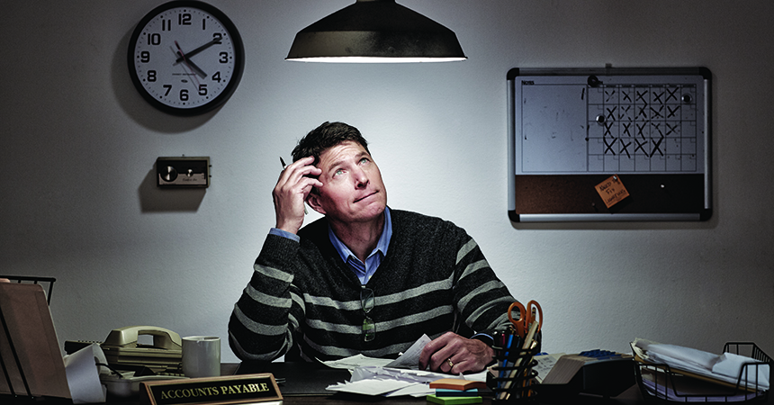 a man looking up at a lightbulb