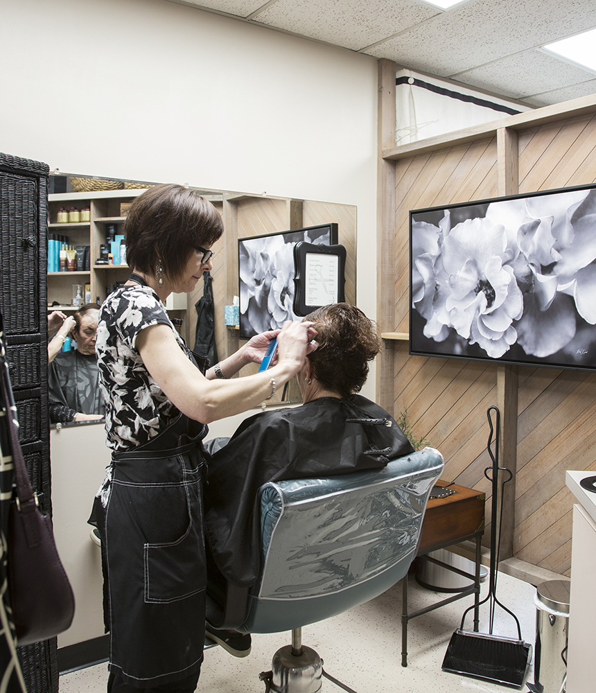 Beth Koblegarde cuts the hair of Carol Sutton at Shears Ahead salon, Tigard, Oregon, April 15, 2019.