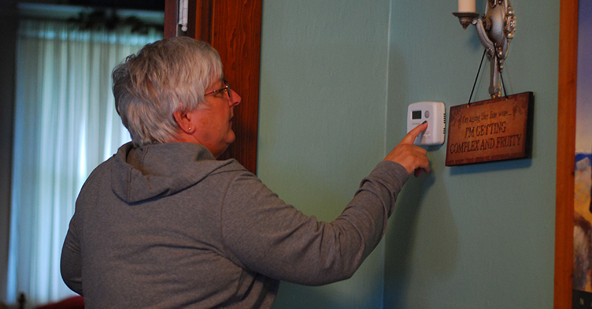 Homeowner with thermostat