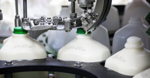 a machine filling up gallons of milk