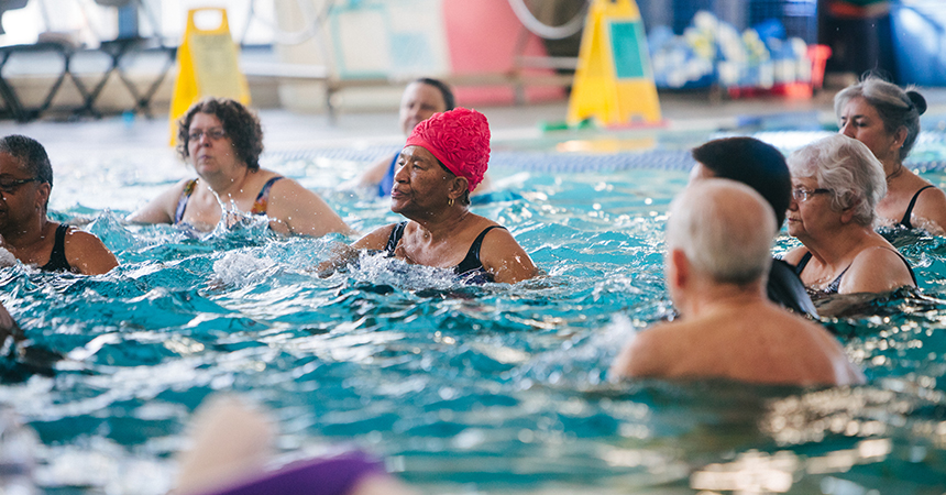 a diverse group of elderly adults in a pool