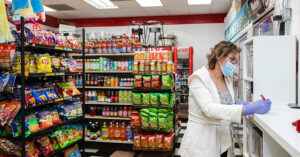 a masked woman shopping in a grocery store