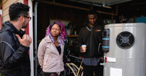 3 people talking near a water heater