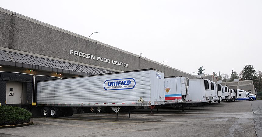 a several trucks outside of a frozen food facility