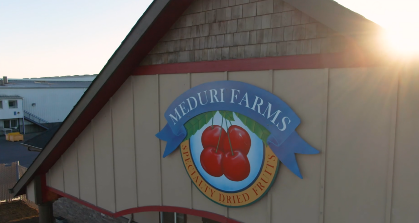 a sign on the side of a building, reading meduri farms