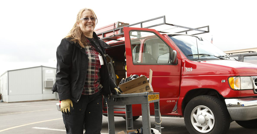 Woman contractor in front of truck