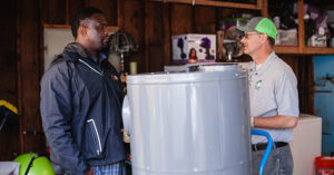 Contractors next to water heater