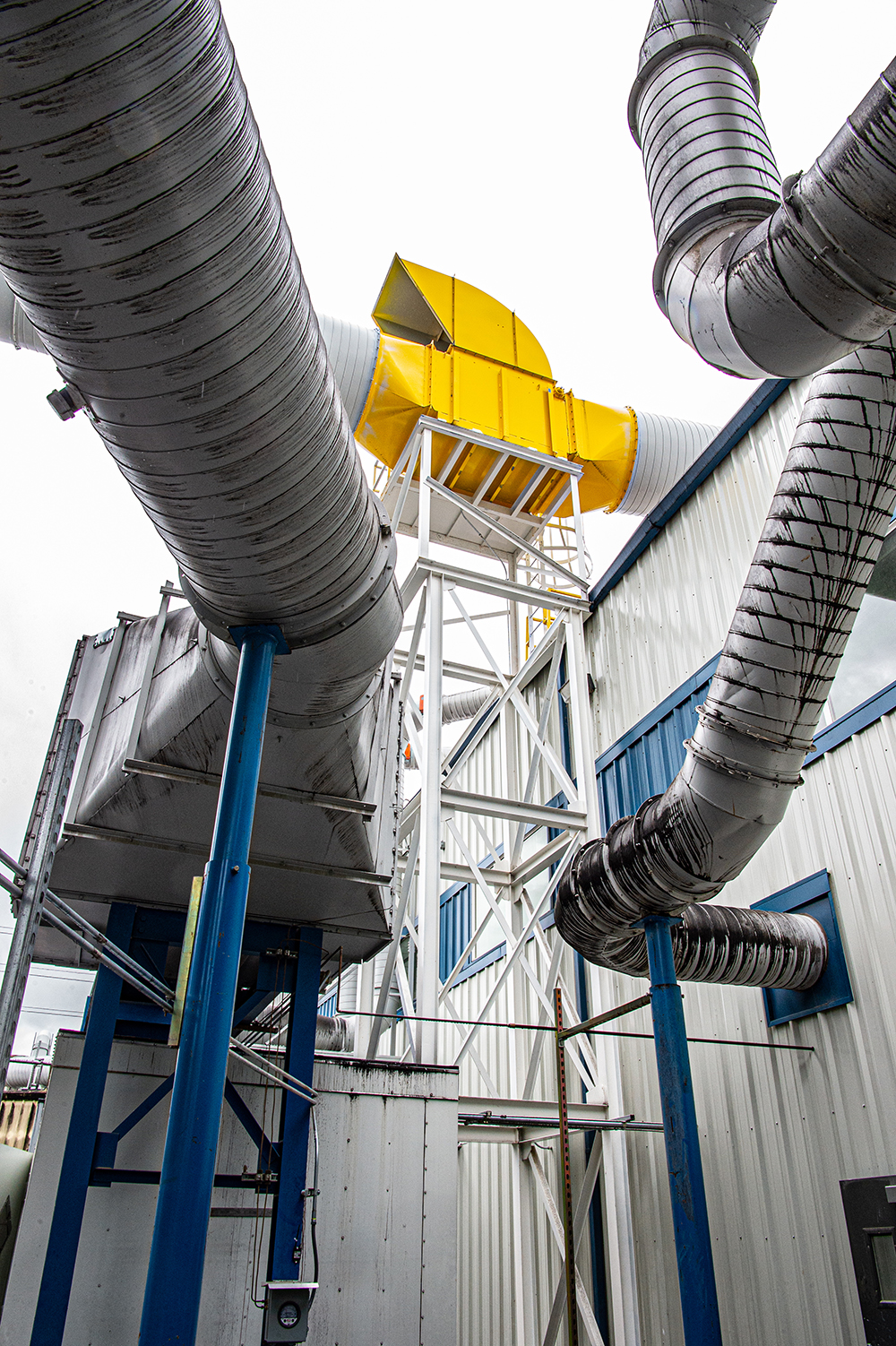 some large ducts on the exterior of a building