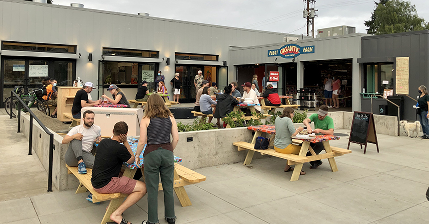 a group of people sitting outside enjoying beers