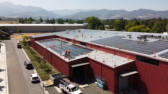 Solar electric panels on roof of building