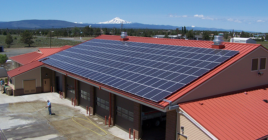 Aerial view of fire station with solar panels on roof