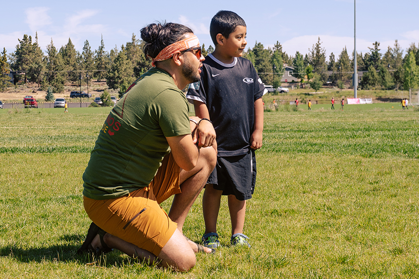 Man and kid on soccer field