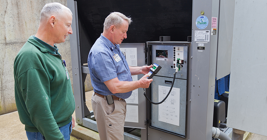 two people looking at hvac controls