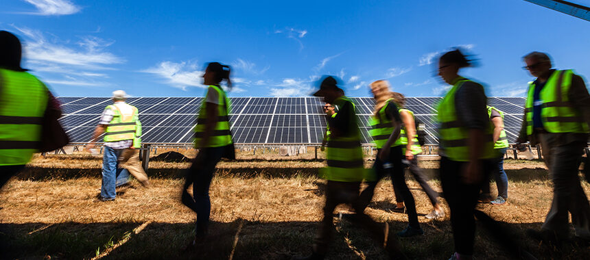 Contractors walking by solar panels