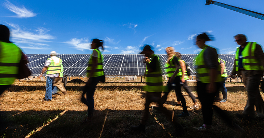 Contractors walking by solar panels