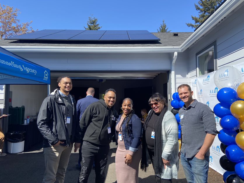 people in front of solar on roof