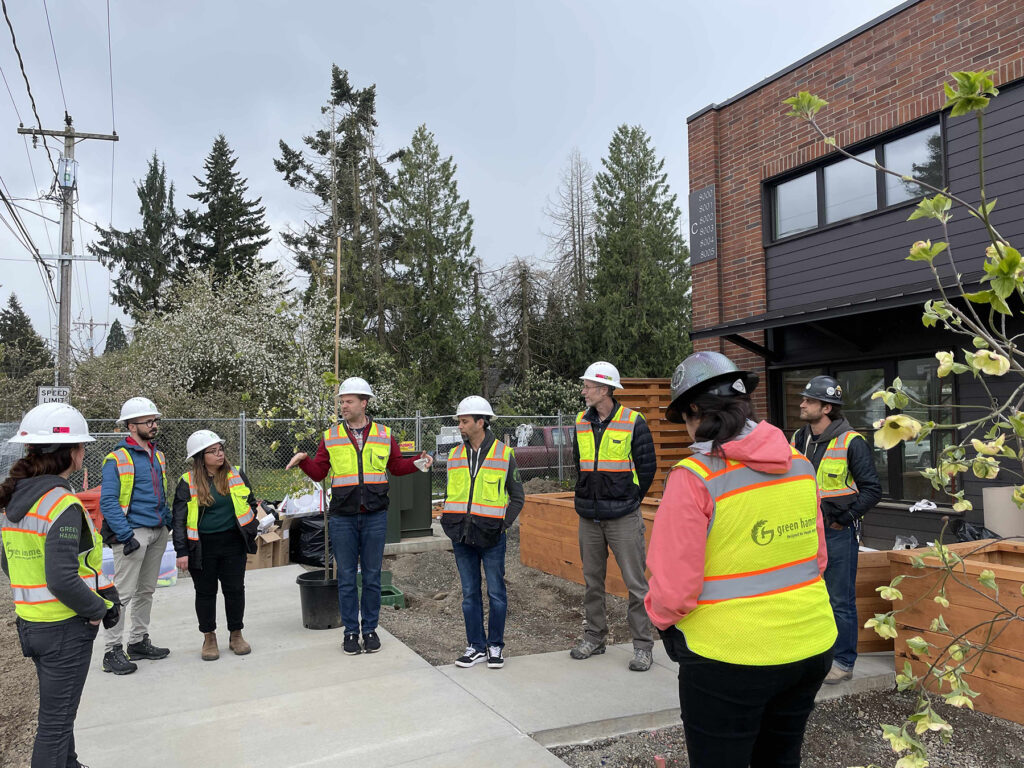 People gathered outside in safety vests