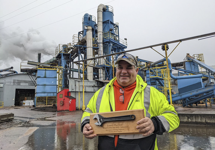 Man in front of industrial piping