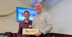 Kevin Harding receives Wrench of the Year Award standing alongside Energy Coach Nick Lorenz.