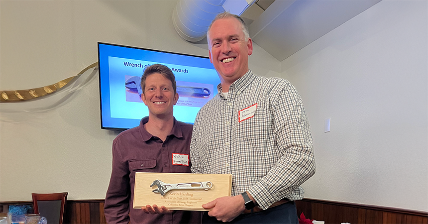 Kevin Harding receives Wrench of the Year Award standing alongside Energy Coach Nick Lorenz.