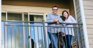 couple standing on apartment balcony