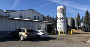Top Hat Mushrooms logo on chemical storage tank makes is easy to find the company in Scio, Oregon