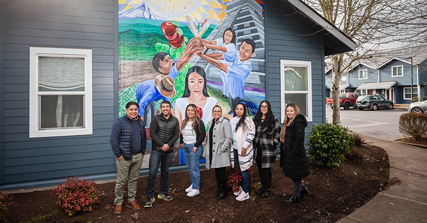 Group of people standing in front of mural