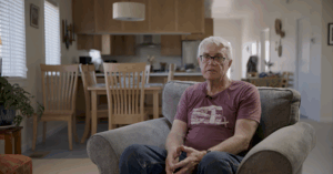 Image of Todd Hoener, Resident in Talent, OR. sitting in his newly rebuilt home.